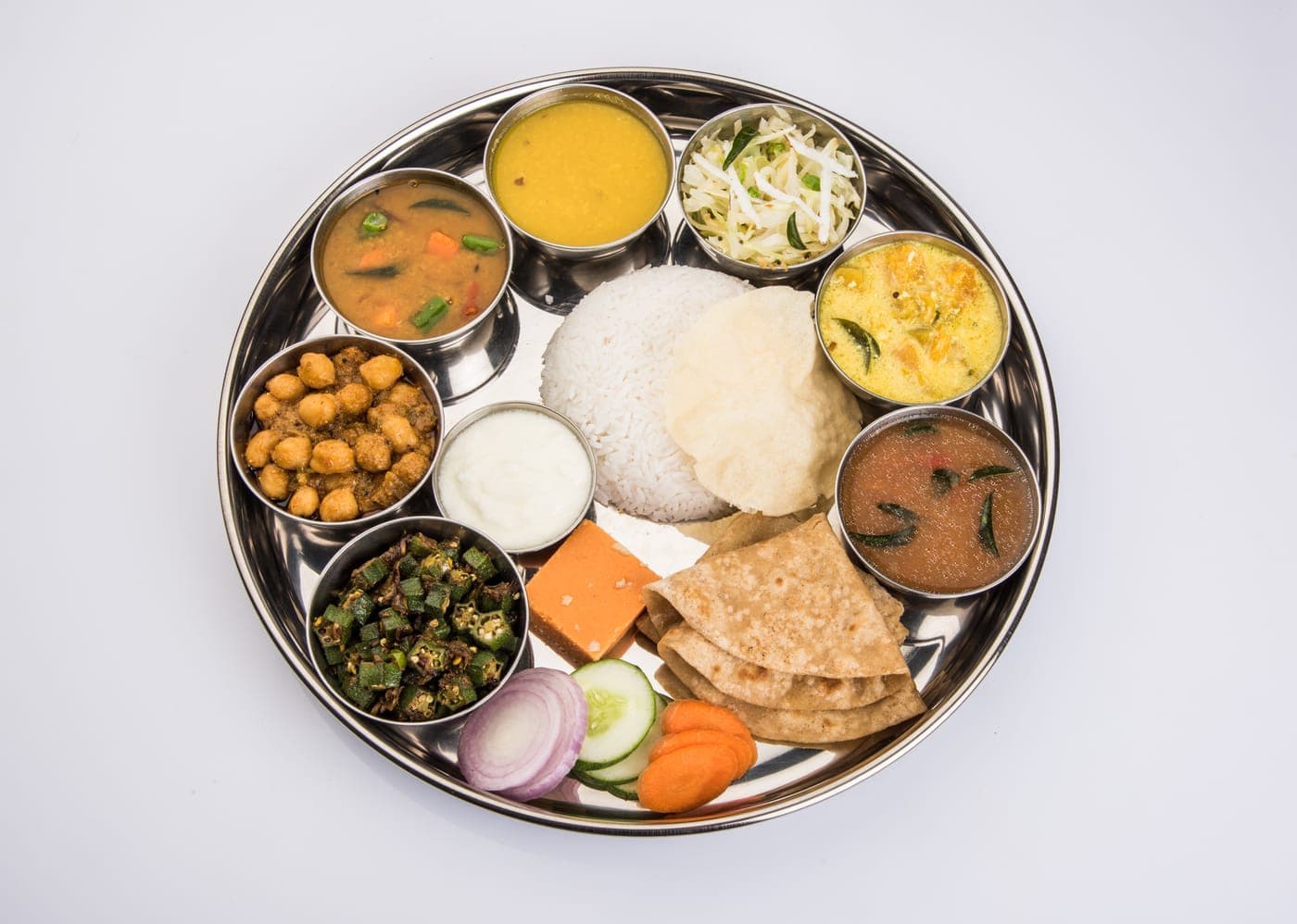 Regular Thali: 4 chapatis, 1 seasonal sabzi, Dal of the day, Steamed rice, Salad & pickle